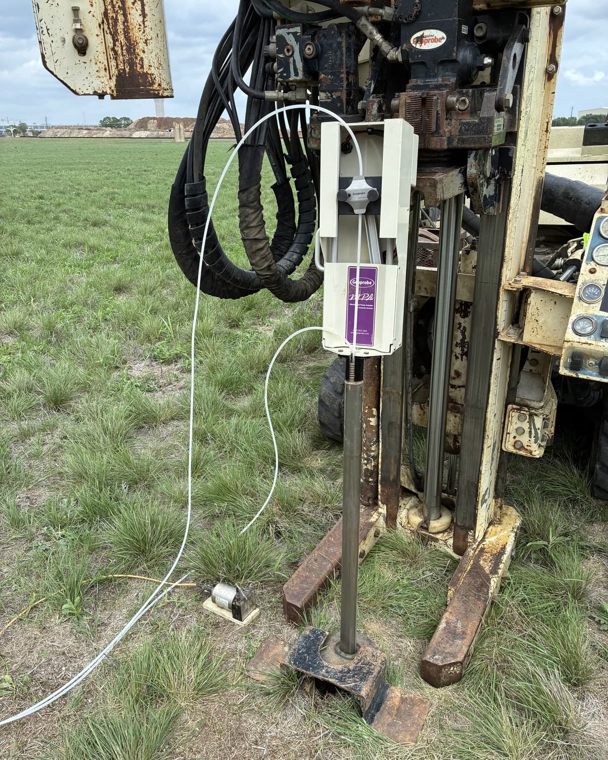A pump actuator mounted on top of the 1.75 in. rods of a Groundwater Profiler, with the sample tubing running out of it